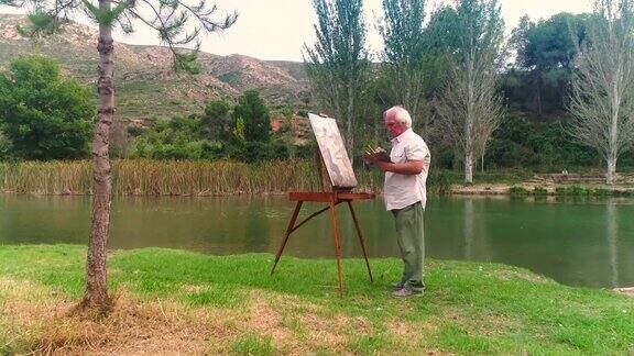 老人在河边作画