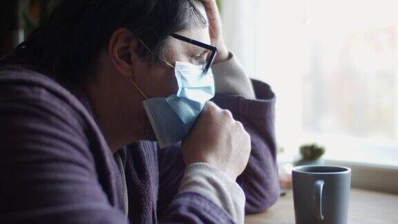 男子生病在家戴防护口罩并咳嗽