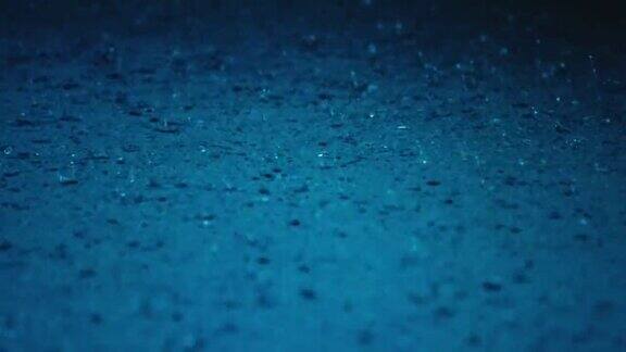 雨水水滴溅入蓝色水坑