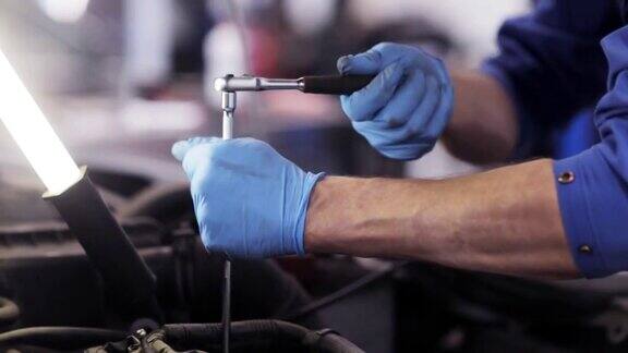 在汽车修理厂用扳手修理汽车的技工