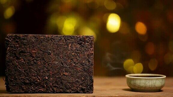 黑色的中国热茶杯木桌金色的散景高清的画面没人