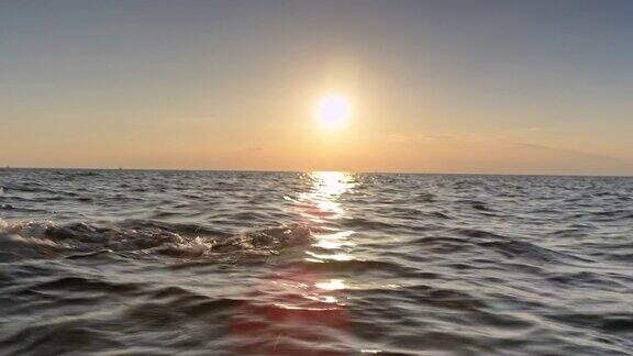 日落时分一名男子在波涛汹涌的海面上游泳