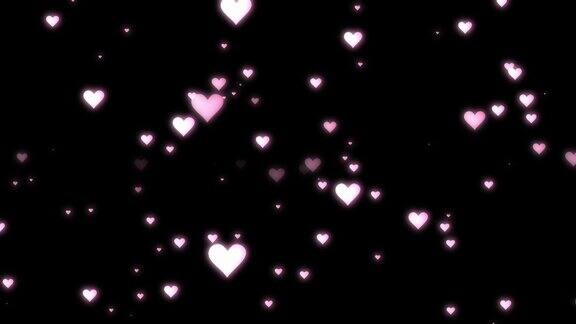粉红色的心形颗粒散布在黑色固体背景上情人节快乐婚礼复制空间