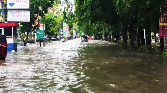 在雅加达汽车通过被洪水淹没的道路