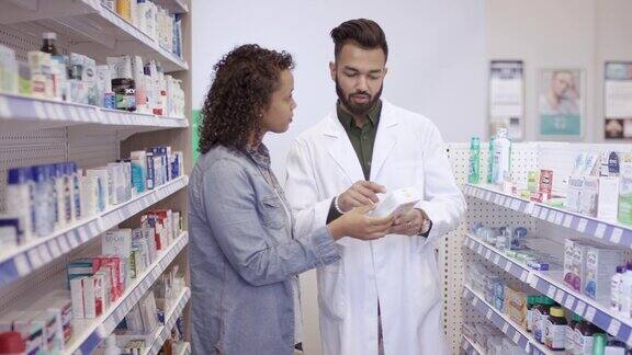 男性药剂师协助女性在药房工作