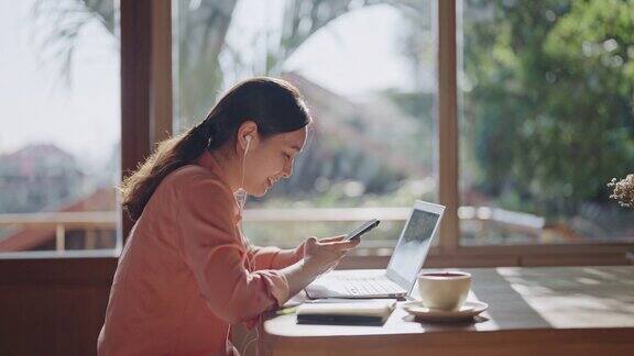 年轻的女商人在咖啡店使用笔记本电脑的时候集中注意力