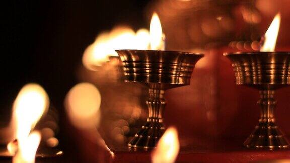 寺庙牛油灯节上的佛坛蜡烛视频在金属容器中祈祷的油灯和摇曳的火焰宁静的风景