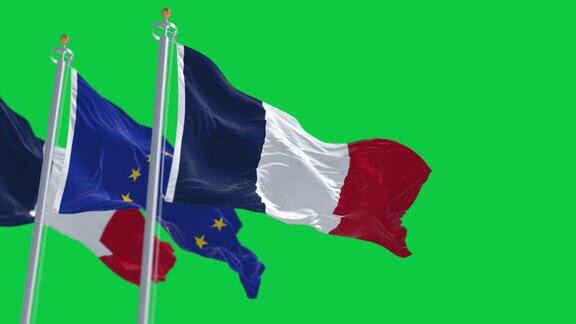 法国和欧盟的旗帜在绿色的背景上孤立地飘扬