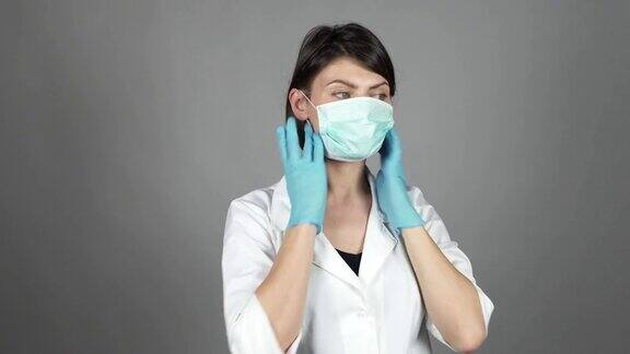 女外科医生戴着绿色手套准备手术戴上口罩医疗保健4k
