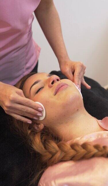 职业女性美容师为她的客户进行面部美容治疗