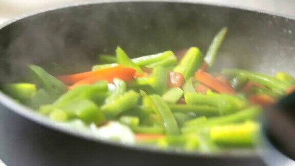 用平底锅搅拌新鲜蔬菜