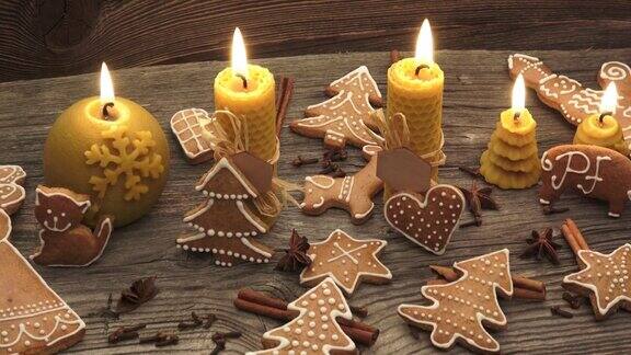 圣诞节自制的姜饼曲奇放在木桌上由天然蜂蜡制成的黄色香味蜡烛