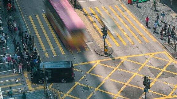 在中国香港尖沙咀区人们和出租车穿过一个非常繁忙的十字路口
