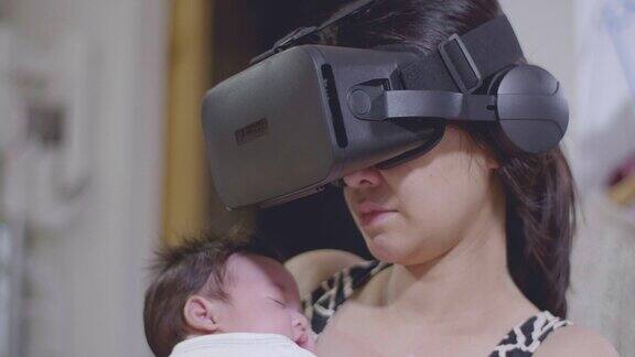 亚洲女性使用VR眼镜男婴趴在胸前睡觉