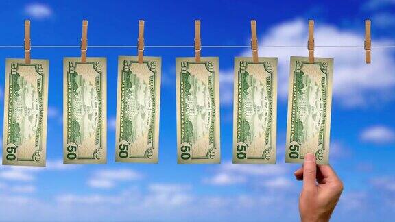 50美元洗衣线传送带背面是50美元纸币背景是天空