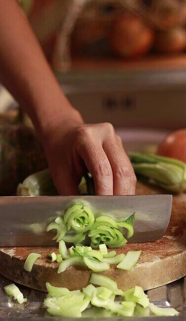 双手在木板上切新鲜的蒲菜