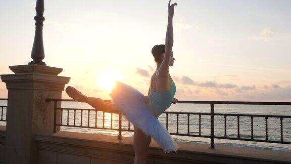 日出时芭蕾舞女演员在码头上表演