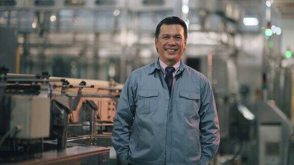 亚洲马来人成熟的男子工厂经理看着相机微笑自信