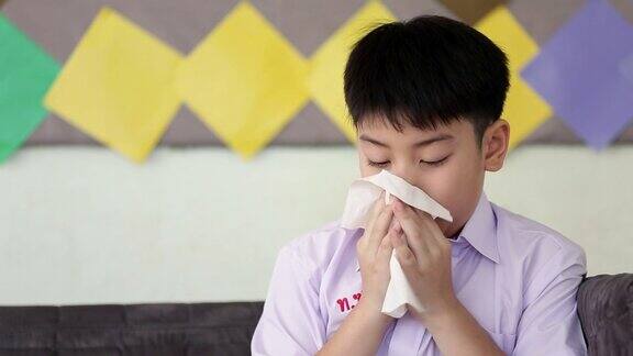 亚洲小孩感冒打喷嚏用纸巾擦干净