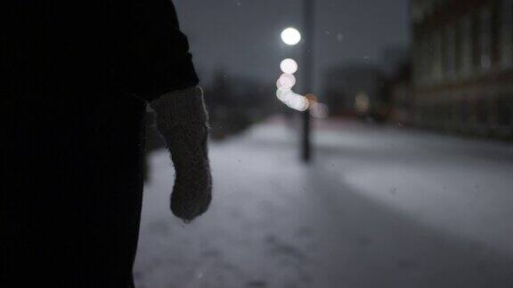 城市里的女人在雪中行走