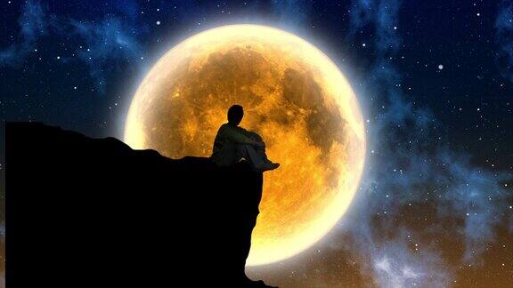 满月背景下山坡上一个人独自沉思的剪影
