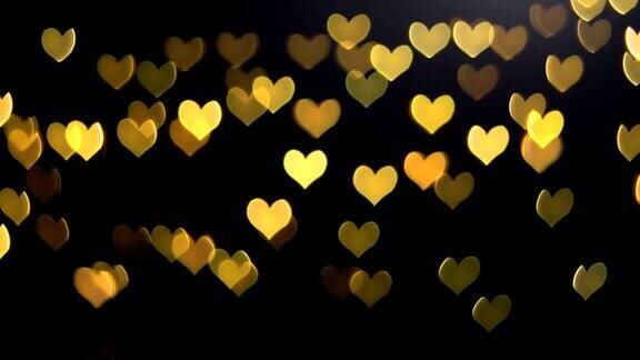 在黑色的背景上金色的心为瓦伦丁的爱调焦