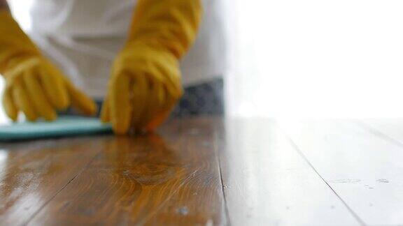 清洁人员用手喷洒清洁木桌用超细纤维布擦拭