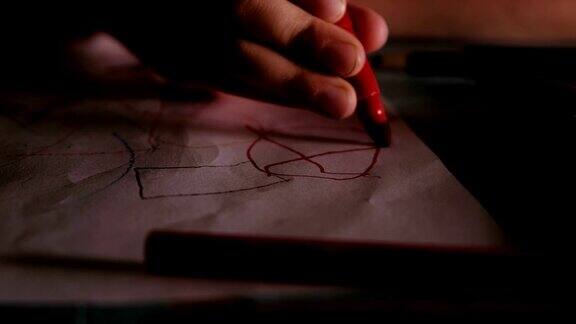 孩子在画孩子在一张纸上画着红色的记号笔特写