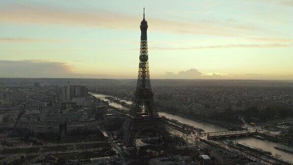 航拍:无人机缓缓地盘旋埃菲尔铁塔游览法国巴黎的埃菲尔铁塔在美丽的夕阳下欣赏塞纳河