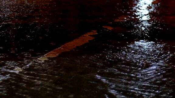在雨天的夜晚交通灯在水面上反射
