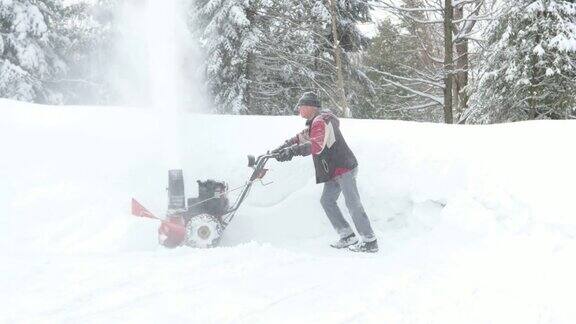 一个老年人在暴风雪后使用吹雪机的4K视频