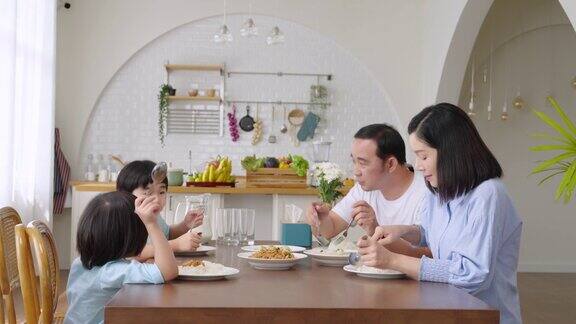 亚洲家庭在一张桌子上吃午餐