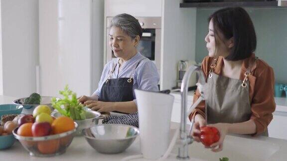 亚洲华人奶奶和孙女在厨房准备早餐