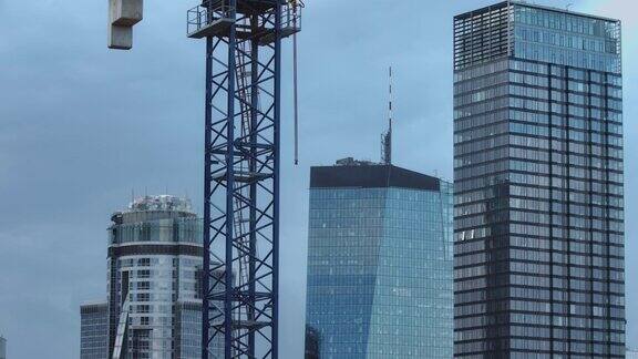 摩天大楼旁边的建筑起重机黎明时分的大城市