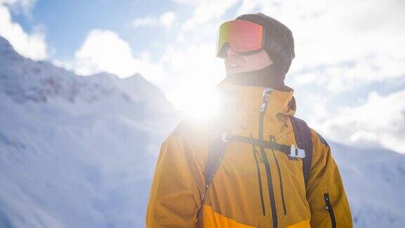 在一个阳光明媚的冬日里滑雪者被雪山包围享受着冬日美景