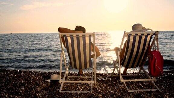 SLOMO夫妇在日落的海滩上放松