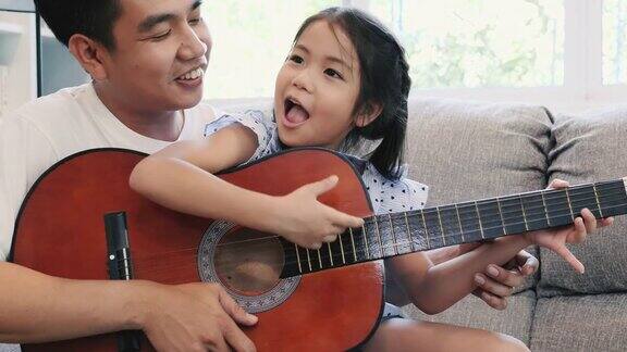 亚洲父亲在家教女儿弹吉他