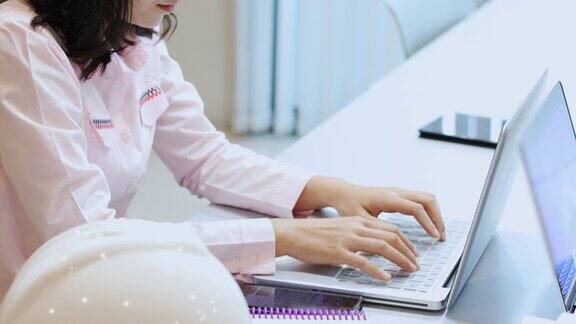 亚洲商业女性使用笔记本和打字工作