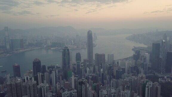 日出鸟瞰图无人机飞行的香港城市与发展的建筑物交通能源电力基础设施