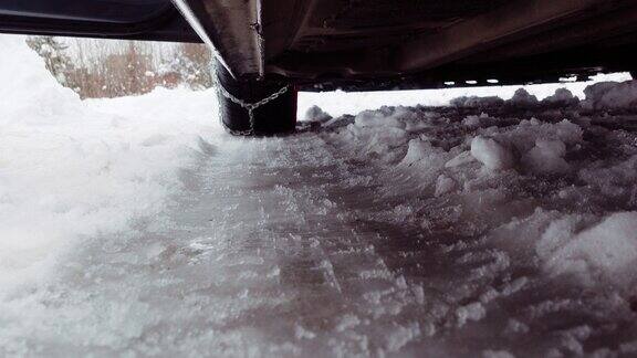 特写轮胎与雪链驾驶在雪和结冰的道路