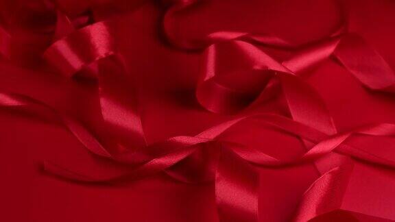 红色旋转背景与红色缎带庆祝情人节或其他节日