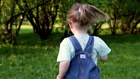 小女孩在草地上奔跑背影慢镜头