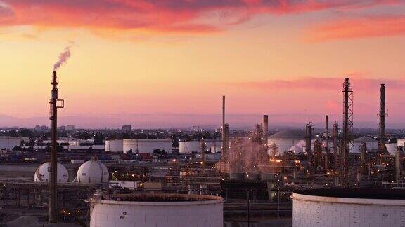 在彩色日落期间的炼油厂烟囱-无人机射击