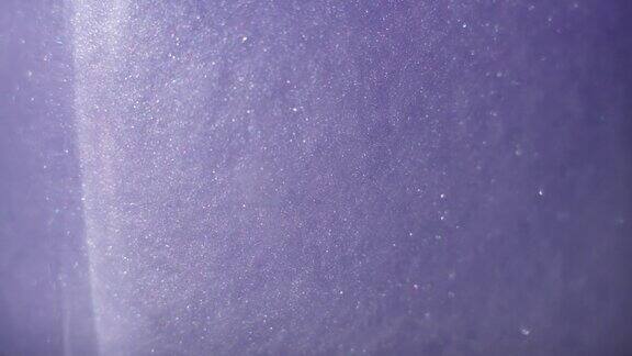 闪闪发光的抽象紫色背景彩色液体在美丽的银色云彩中旋转闪闪发光的尘埃在水中缓慢移动惊人的抽象纹理背景