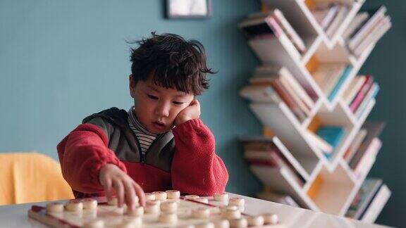 一个小男孩在下中国象棋