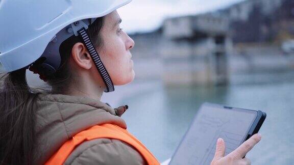在水电站大坝工作的女工程师以生态为导向可再生能源系统