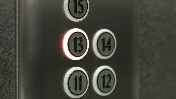 一个男人在电梯里按下了13层的按钮