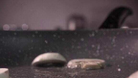 切片蘑菇放入煎锅的慢镜头每秒480帧