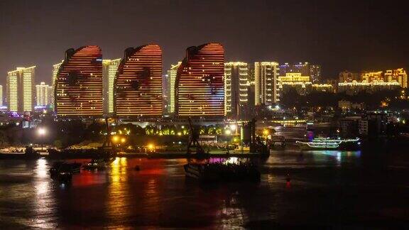 夜晚照明海南岛三亚湾公寓综合体全景4k时间推移的中国