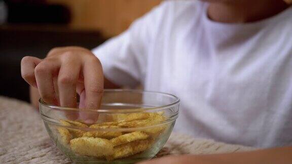 小孩的手从盘子里拿饼干食用有害的零食快餐